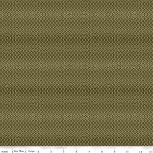 May include: Close-up of a fabric with a repeating pattern of small, dark brown crosses on a khaki green background. The fabric has a textured appearance. A ruler with inches is at the bottom of the image.