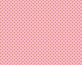 May include: Pink fabric with a repeating pattern of small, evenly spaced brown polka dots. The fabric has a smooth texture and is suitable for various sewing and crafting projects. The image includes a ruler at the bottom.