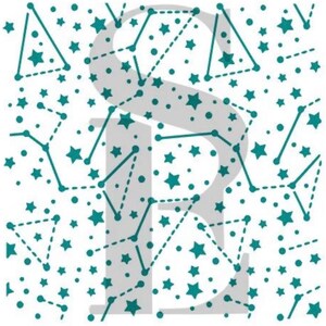 May include: A white ceramic mug with a black handle and the text "But First, Coffee" in a bold, black font. The mug is set against a blurred background, suggesting a cozy setting.