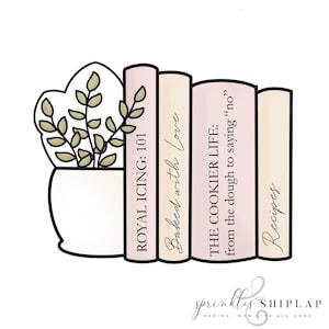 May include: A cookie cutter in the shape of a stack of books, with a plant in a pot on the left. The books are labeled "ROYAL ICING: 101", "Baked with Love", "THE COOKIER LIFE", and "Recipes".
