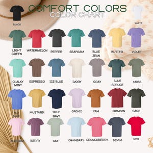Op de afbeelding: Een kleurenkaart met een verscheidenheid aan t-shirts in verschillende kleuren, waaronder zwart, wit, rood, blauw en groen. De tekst "COMFORT COLORS" en "COLOR CHART" staat bovenaan de afbeelding. Elk shirt is gelabeld met zijn kleurnaam.