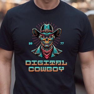 May include: A black t-shirt with a graphic of a robot wearing a cowboy hat. The robot has a skull-like face with glowing blue eyes. The text "DIGITAL COWBOY" is printed below the robot in a retro pixelated font.