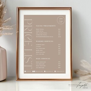 May include: A beige and white price list for a beauty salon. The price list is framed in a gold frame and is hanging on a wall. The price list includes prices for facial treatments, waxing services, and nail services.