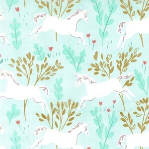 May include: A repeating pattern of white unicorns, gold-colored trees, and green foliage on a light blue background. Small red flowers are scattered throughout the design. The unicorns are depicted in a running pose.