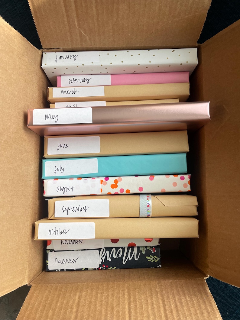 12 Cute wrapped blind date books labeled with each month of the year and genre.