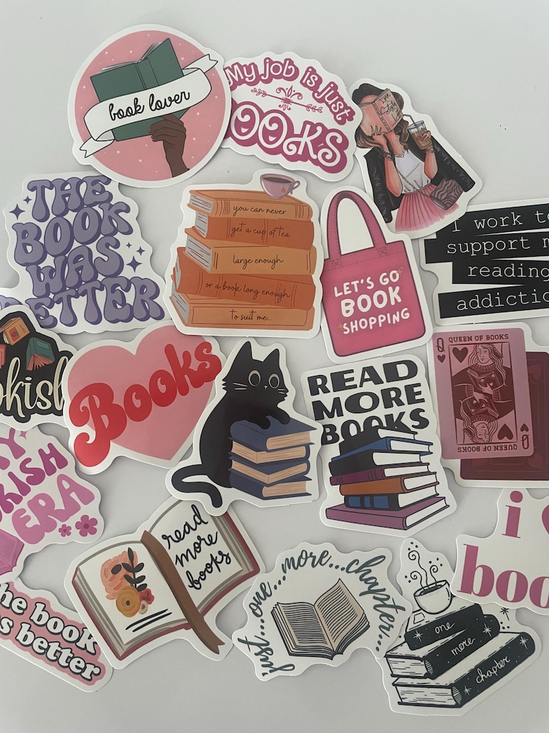 May include: A collection of stickers with book-themed designs. The stickers feature phrases like "book lover," "read more books," and "My job is just books." Various stickers depict stacks of books, open books, and a black cat with books.