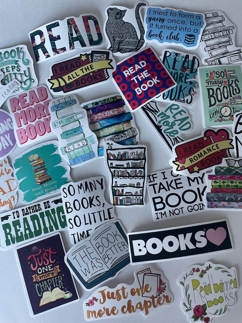 May include: A collection of colorful stickers with book-related themes. The stickers feature phrases like "Read," "Books," and "Just one more chapter." Some stickers have illustrations of books, cats, and bookshelves. The stickers are in various shapes and sizes.
