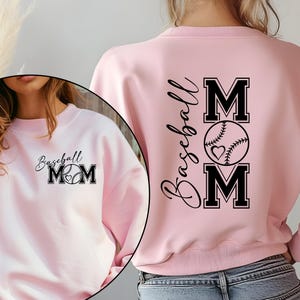 May include: Pink sweatshirt with the text "Baseball Mom" and a baseball graphic on the front and back.