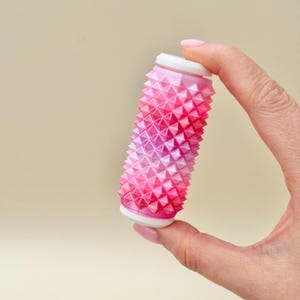 Pink and white spiky sensory roller, rigid stim toy for strong pressure seekers.