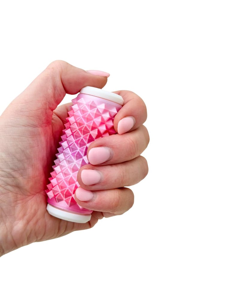 Pink spiky sensory roller for deep pressure input, quiet handheld pain stim fidget.