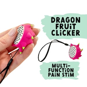 May include: A pink dragon fruit shaped clicker with a black and white patterned surface. The clicker has a black strap and the text "Dragon Fruit Clicker" and "Multi-Function Pain Stim" are printed on the image.