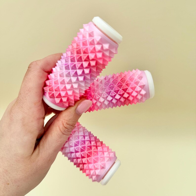 Pink textured pressure roller, palm-sized stim tool for anxiety and self-regulation.