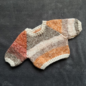 Hand knitted jumper for a doll or bear