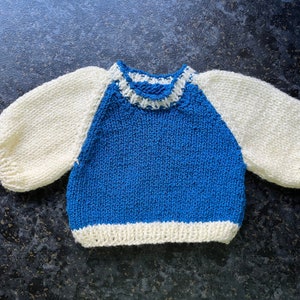 Hand knitted jumper for a doll or bear