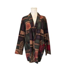May include: A long-sleeved open-front jacket featuring a dark color palette of forest green, deep purple, and burgundy. The fabric displays a repeating geometric pattern with ornate scrollwork and circular motifs throughout the entire garment.