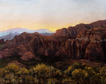 May include: An oil painting depicts a desert landscape with reddish-brown rock formations under a pale sky. The foreground features golden-yellow bushes, with layers of mountains fading into the distance. The sky transitions from yellow to a soft blue.