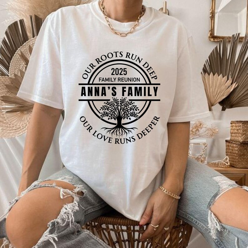 May include: White t-shirt with a black circle design featuring a tree and the text "Our Roots Run Deep 2025 Family Reunion Anna's Family Our Love Runs Deeper".