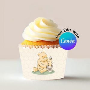 May include: A cupcake with a yellow sponge base and a swirl of white icing. The cupcake case has a cartoon bear illustration beside a honey pot. The text "Free Edit With Canva" is on the right.
