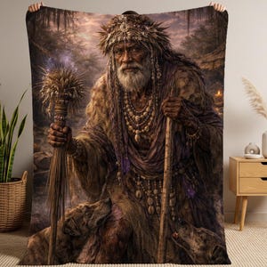 May include: A digitally created blanket featuring an elderly figure with a long white beard, adorned with beads and a headdress. The figure holds a staff and a bundle of wheat, with two dogs at their feet. The color palette is dominated by earthy tones.