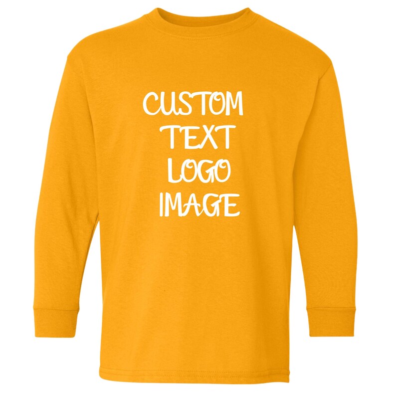 May include: Mustard yellow long-sleeve shirt with the words "CUSTOM TEXT LOGO IMAGE" in white block letters. The shirt has a crew neck and long sleeves. The shirt is made of a soft material.