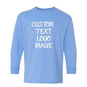 May include: A light blue long-sleeve shirt with the words "CUSTOM TEXT LOGO IMAGE" printed in white. The shirt has a crew neck and long sleeves. The text is centered on the front of the shirt.