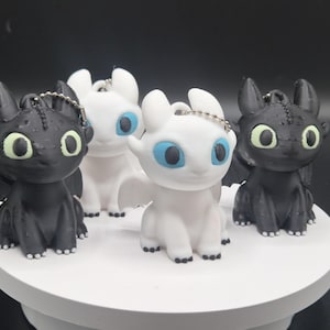 Toothless and Light Fury Clicker Keychains | How to Train Your Dragon