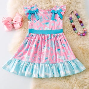Turquoise and blue western printed girls dress with side bows.
