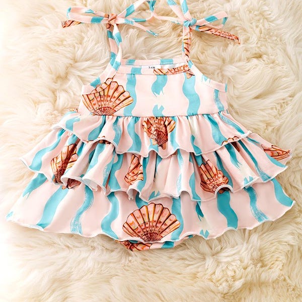 Seashell printed girls baby onesie with ruffle layer. RPG50642
