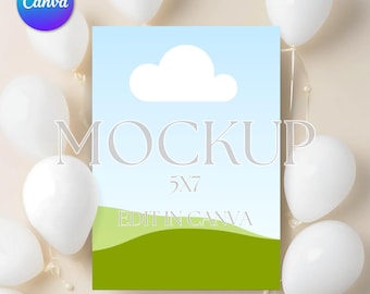 May include: A 5x7 inch white card mockup with a blue sky, white cloud, and green grass design. The text "MOCKUP" and "EDIT IN CANVA" are on the card. The card is surrounded by white balloons.