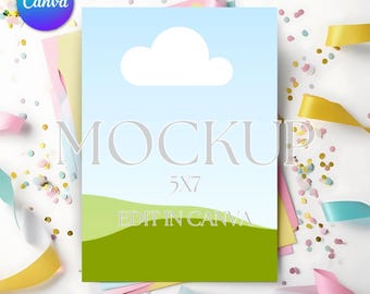 May include: A mockup of a 5x7 inch card with a blue sky, white cloud, and green grass. The text "MOCKUP" and "EDIT IN CANVA" are on the card. The card is surrounded by colorful confetti and ribbons.