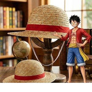 May include: Two straw hats with red bands, one large and one small, are displayed on a wooden stand. A cartoon character in a red jacket and blue shorts stands next to the hats. The hats are reminiscent of the anime series One Piece.