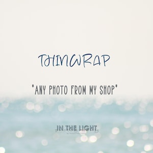 May include: A blue and white text graphic on a white background with a blurred image of blue water with white highlights in the background. The text reads "Thinwrap" and "Any photo from my shop". Below the text is a logo that reads "In the Light Photography by Tessa Photography".