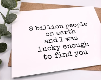 May include: A white card with black text that reads "8 billion people on earth and I was lucky enough to find you".