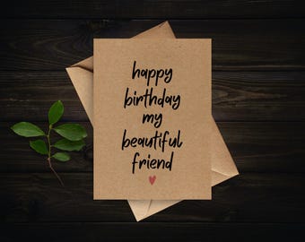 May include: A birthday card with the message "happy birthday my beautiful friend" in black script. The card is on a kraft paper background with a small red heart. An envelope and a sprig of green leaves are also visible.