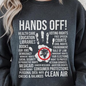 Hands Off Shirt, Hands Off Rally, Hands Off Protest Shirt, Political Activism Shirt, Resist Shirt, Hands Off Social Security Tee, Protest, Bella+Canvas 3001 T-Shirt, Gildan Sweatshirt & Hoodie, social security, hands off shirt, medicare shirt, anti trump shirt, political activism, resist shirt, anti elon musk tee, hands off medicaid, hands off political, hands off protest, hands off rally, hands of our jobs, protest shirt