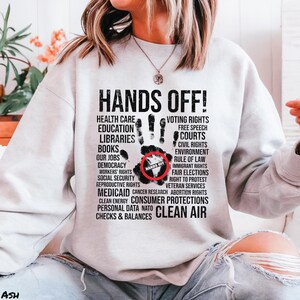 Hands Off Shirt, Hands Off Rally, Hands Off Protest Shirt, Political Activism Shirt, Resist Shirt, Hands Off Social Security Tee, Protest, Bella+Canvas 3001 T-Shirt, Gildan Sweatshirt & Hoodie, social security, hands off shirt, medicare shirt, anti trump shirt, political activism, resist shirt, anti elon musk tee, hands off medicaid, hands off political, hands off protest, hands off rally, hands of our jobs, protest shirt