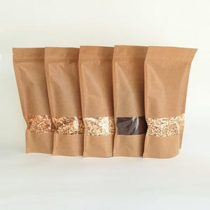 May include: A white ceramic mug with a black handle and the text "But First, Coffee" in a handwritten style. The mug is on a white surface. The mug is 4 inches tall.