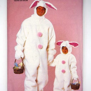 May include: A Butterick 6866 sewing pattern envelope featuring a white plush bunny costume with long ears, pink accents, and two pink pom-poms on the front. The pattern includes instructions for two sizes, shown on a pink background with woven baskets.