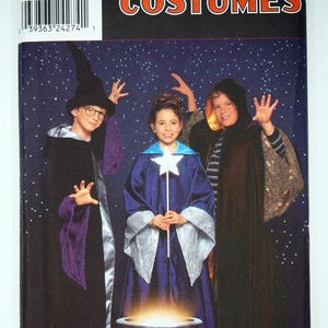 May include: A Simplicity Costumes sewing pattern envelope for sizes 7, 8, 10, 12 and 14. The cover features three children in wizard and sorcerer costumes, including robes, a pointed hat and a star-topped wand, standing before a glowing cauldron.
