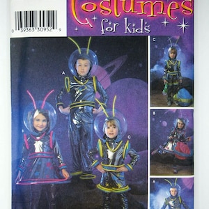 May include: A Simplicity 3661 sewing pattern envelope for children's space-themed costumes. The cover features illustrations of children wearing metallic jumpsuits, skirts, and clear bubble helmets with antennae, set against a purple space background.
