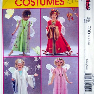 May include: A McCall's Costumes sewing pattern envelope, model M5152, featuring four variations of fairy-style costumes for children. The designs include a green dress with wings, a red dress with gold sleeves, a white robe, and a pink dress with floral accents.