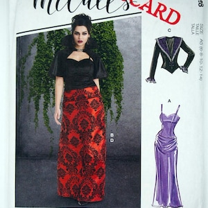May include: McCall's sewing pattern featuring a woman in a black top and red patterned skirt. The pattern includes illustrations of a long purple dress and a black jacket with purple trim. The word "McCall's" is in cursive.