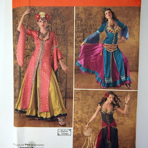 May include: Simplicity sewing pattern featuring three costume designs. The pattern includes a red and gold dress, a blue and pink outfit, and a black and red dress. The pattern size is R5, sizes 14, 16, 18, 20, and 22.