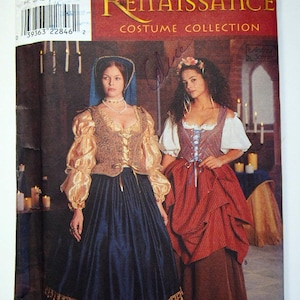 May include: Simplicity Renaissance Costume Collection sewing pattern number 8715 for sizes 10, 12, and 14. The pattern includes two Renaissance-era costumes, one with a gold and blue skirt and the other with a red and brown skirt.