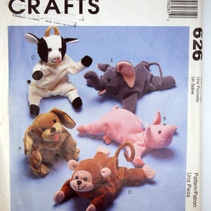May include: A McCall's Crafts pattern for making plush stuffed animals, including a cow, elephant, dog, monkey, and pig. The pattern is titled "Bambeanies" and has the number 626. The pattern is in a paper envelope.