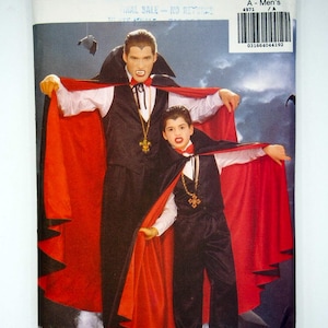 May include: Butterick pattern 4971 for men's vampire costumes. The image shows a man and a boy dressed in black vests, pants, and capes with red linings. The costumes include white shirts and gold cross necklaces. The pattern's packaging is visible.