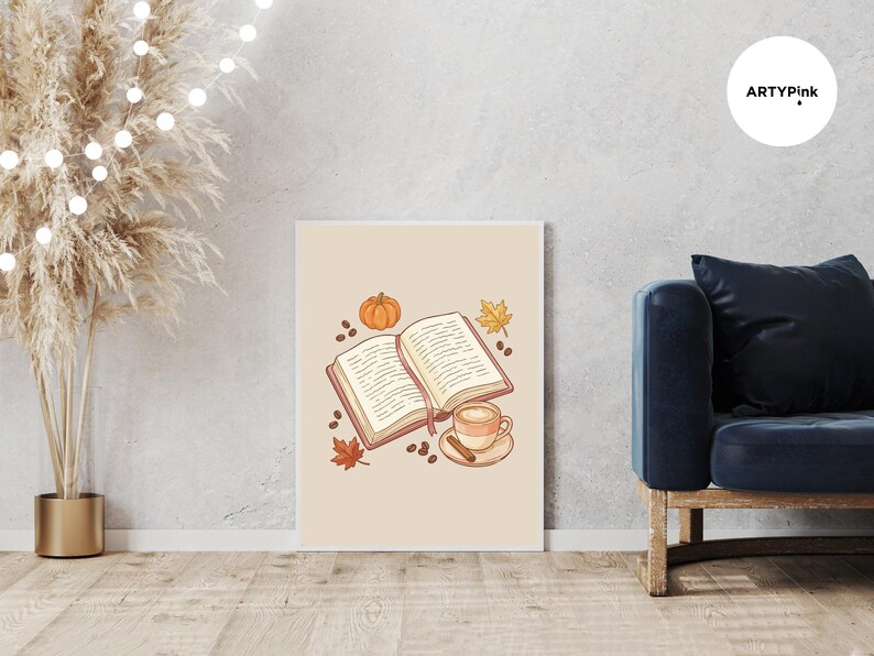 May include: A rectangular wall art print featuring a central illustration of an open book with a pink bookmark, a small orange pumpkin, a steaming cup of coffee on a saucer with a cinnamon stick, scattered coffee beans, and autumn leaves.