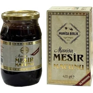 May include: A jar of dark Manisa Mesir Macunu, a Turkish herbal paste, and its box. The jar has a gold lid and a label with gold lettering. The box is beige with gold accents and text, including "Manisa Birlik" and "420 g".