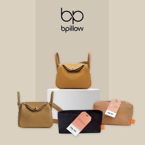 May include: A collection of tan-colored handbags and accessories. The image features two handbags with top handles, a black organizer, and a small pouch. The brand logo "bpillow" is displayed at the top.