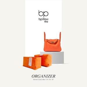 May include: Orange felt organizer for a Hermes Lindy bag. The organizer is designed to fit the Mini, 26, 30, and 34 sizes of the bag. The organizer is shown on a white surface.
